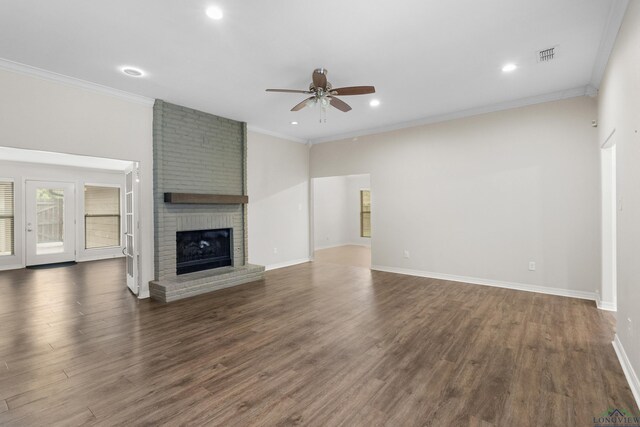 unfurnished living room with a ceiling fan, visible vents, dark wood-type flooring, and a brick fireplace