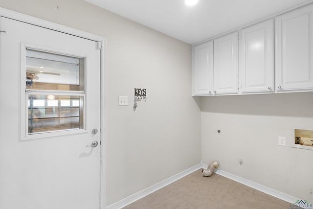 laundry area with baseboards, washer hookup, cabinet space, electric dryer hookup, and gas dryer hookup