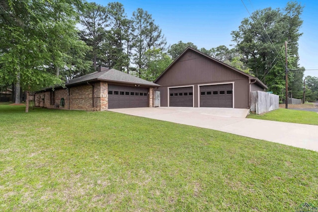 view of front of house with fence, brick siding, a front yard, and a garage