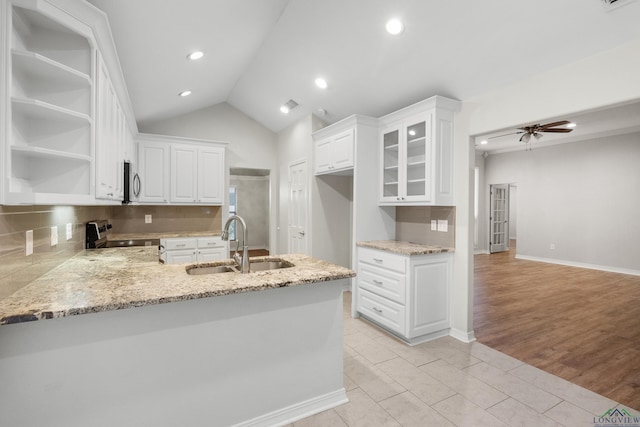 kitchen with open shelves, tasteful backsplash, stainless steel appliances, and a sink