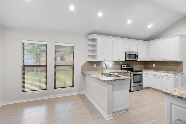 kitchen featuring white cabinets, stainless steel appliances, a peninsula, and a sink