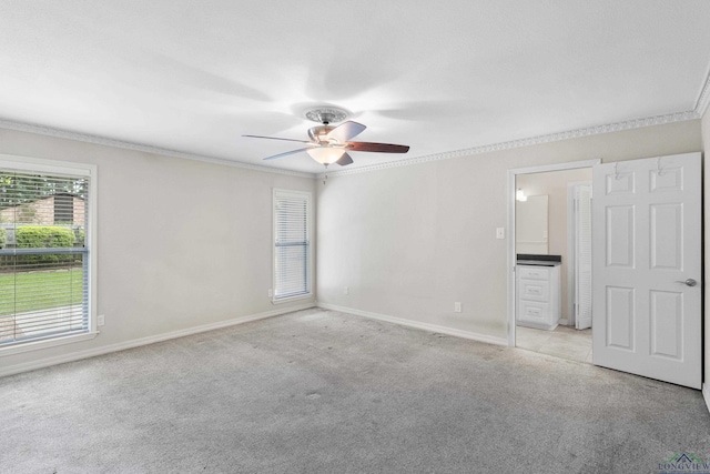 unfurnished bedroom with baseboards, ornamental molding, and light colored carpet