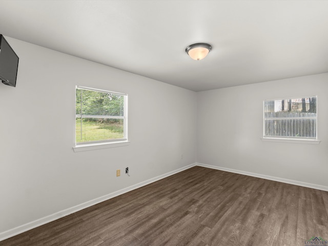 306 W Gilmer, Big Sandy, TX 75765 - unfurnished room with dark wood-style flooring and baseboards