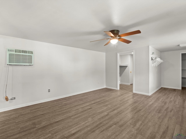 306 W Gilmer, Big Sandy, TX 75765 - unfurnished living room with ceiling fan, wood finished floors, and a wall unit AC