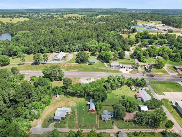 306 W Gilmer, Big Sandy, TX 75765 - aerial view of property and surrounding area with a heavily wooded area
