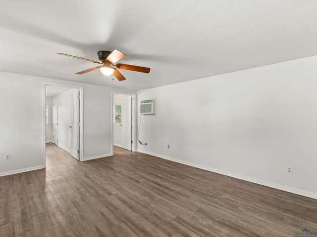 306 W Gilmer, Big Sandy, TX 75765 - spare room featuring a ceiling fan, dark wood-type flooring, and a wall unit AC