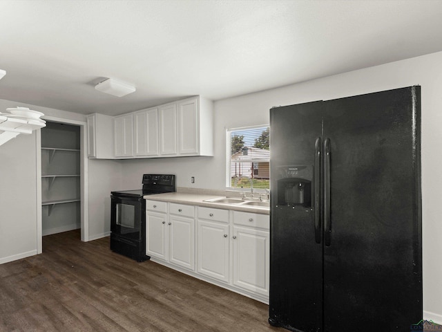 306 W Gilmer, Big Sandy, TX 75765 - kitchen featuring black appliances, dark wood-type flooring, white cabinetry, and light countertops