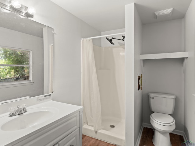 306 W Gilmer, Big Sandy, TX 75765 - bathroom featuring wood finished floors, vanity, and a stall shower