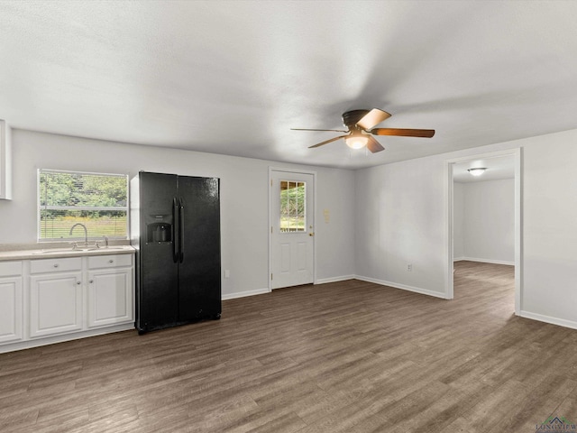 306 W Gilmer, Big Sandy, TX 75765 - unfurnished living room with a ceiling fan and light wood-style flooring