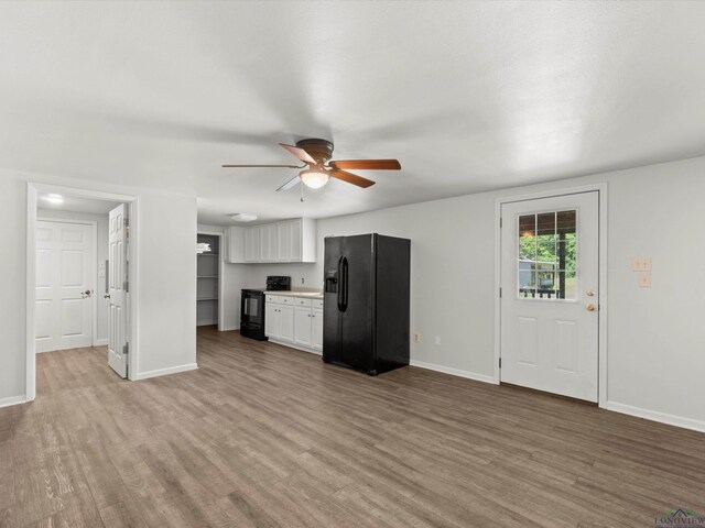 306 W Gilmer, Big Sandy, TX 75765 - unfurnished living room featuring a ceiling fan and light wood finished floors