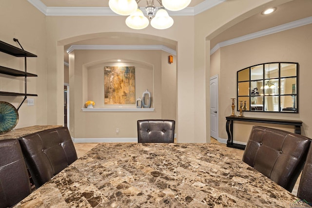 dining room featuring crown molding and an inviting chandelier