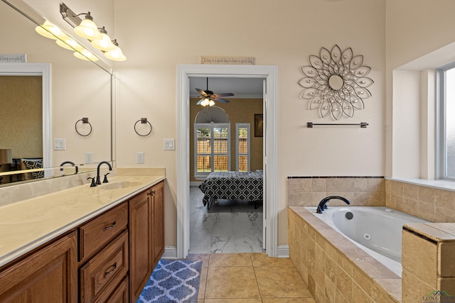 bathroom with vanity, a relaxing tiled tub, and ceiling fan