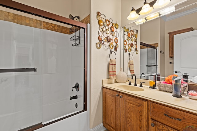 bathroom with shower / bath combination with glass door, vanity, and crown molding