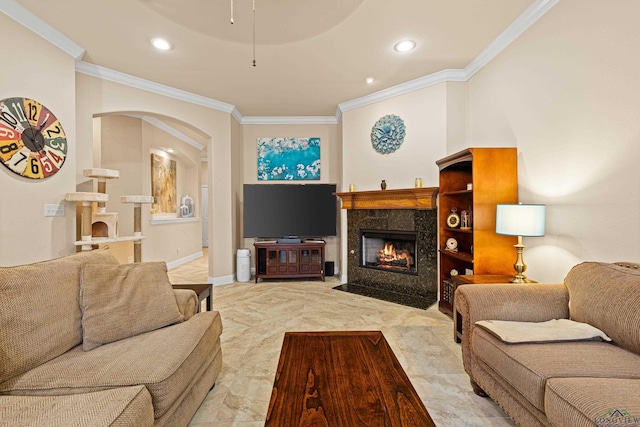 living room featuring ceiling fan, ornamental molding, and a fireplace