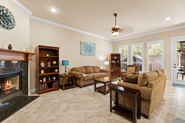 living room featuring ceiling fan, a fireplace, and ornamental molding