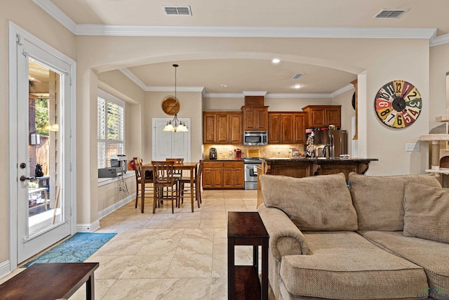 living room featuring crown molding and a notable chandelier