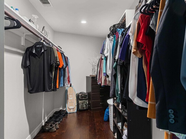 walk in closet with dark wood-type flooring