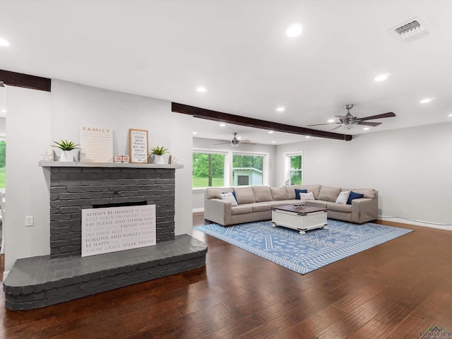 living room with beam ceiling, ceiling fan, a fireplace, and wood-type flooring