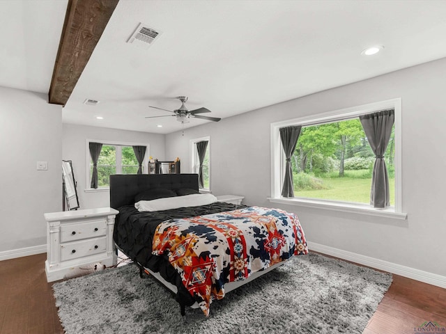 bedroom featuring ceiling fan, beam ceiling, and dark hardwood / wood-style flooring