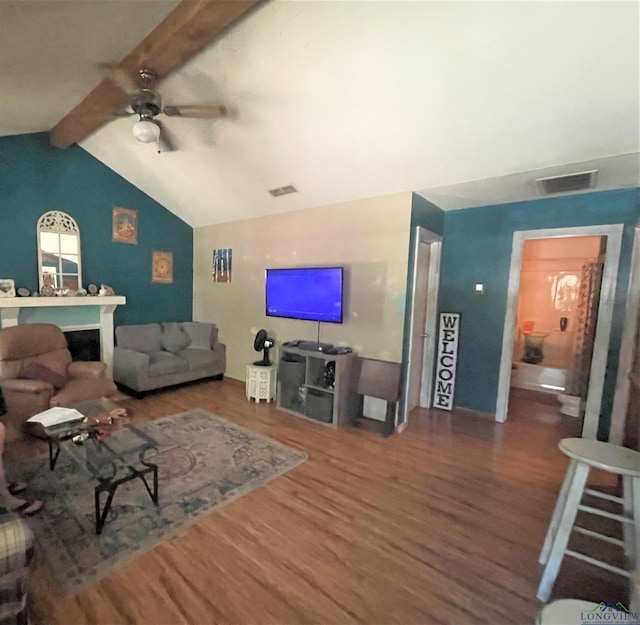 living room with vaulted ceiling with beams, ceiling fan, and wood-type flooring