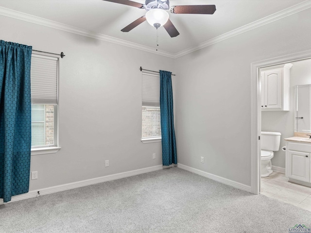 unfurnished bedroom with crown molding, connected bathroom, light carpet, and ceiling fan