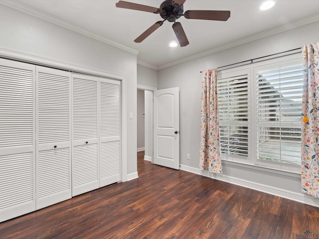 unfurnished bedroom with crown molding, ceiling fan, dark hardwood / wood-style flooring, and a closet