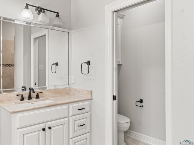 bathroom with vanity, toilet, and tile patterned flooring