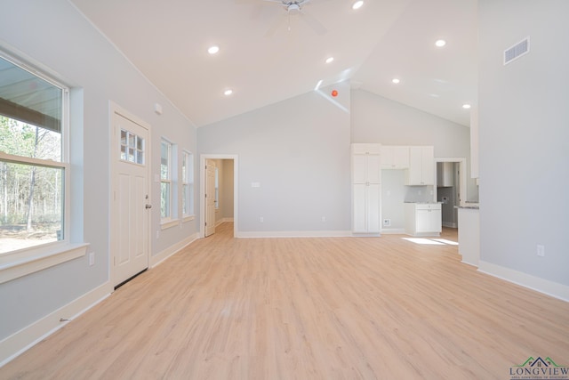 unfurnished living room with ceiling fan, high vaulted ceiling, and light hardwood / wood-style flooring