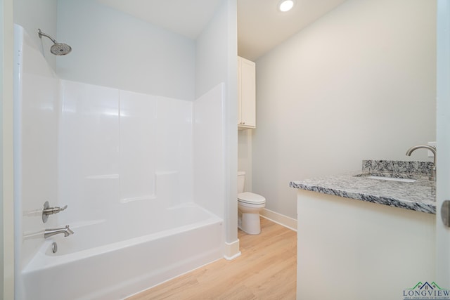 full bathroom featuring vanity, toilet, wood-type flooring, and tub / shower combination