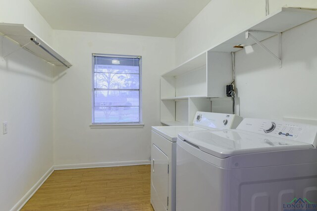 laundry area featuring light wood-type flooring and independent washer and dryer