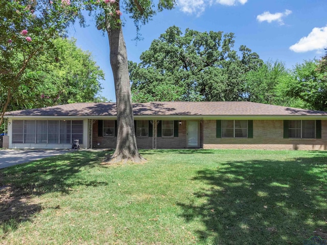 ranch-style house with a garage and a front lawn