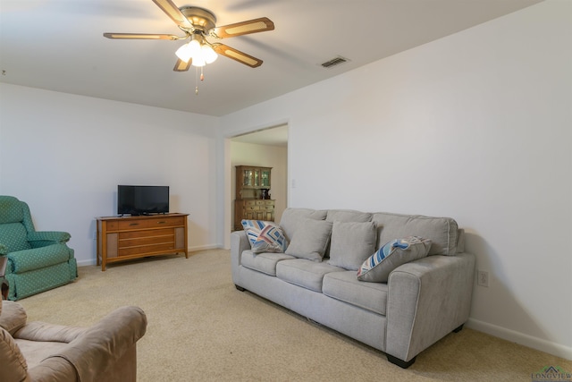 carpeted living room with ceiling fan