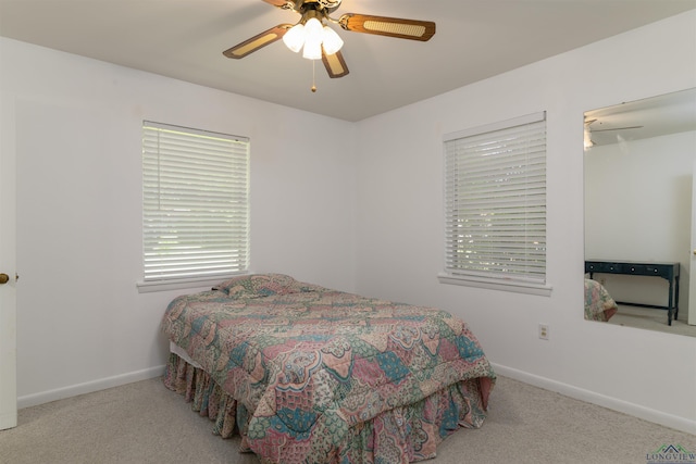 bedroom featuring light colored carpet and ceiling fan