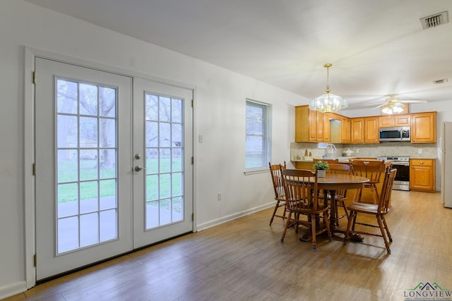 dining space featuring french doors, ceiling fan, and light hardwood / wood-style flooring