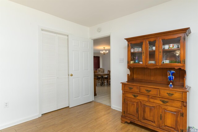 dining room with ceiling fan with notable chandelier and wood-type flooring