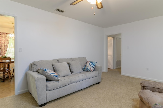 living room with ceiling fan and light carpet