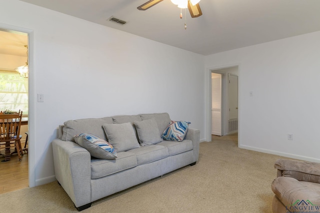 carpeted living room featuring ceiling fan