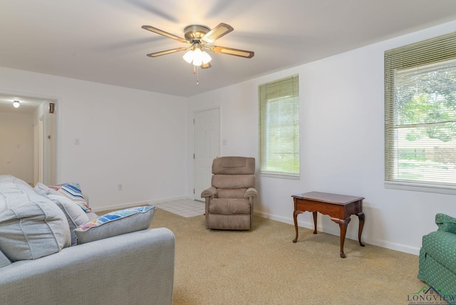 sitting room featuring light carpet and ceiling fan