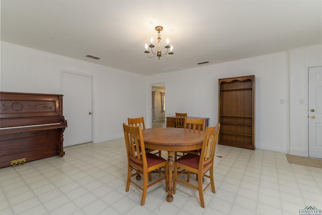 dining area featuring an inviting chandelier