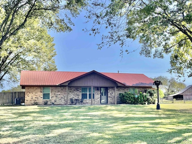 ranch-style house with central AC and a front lawn