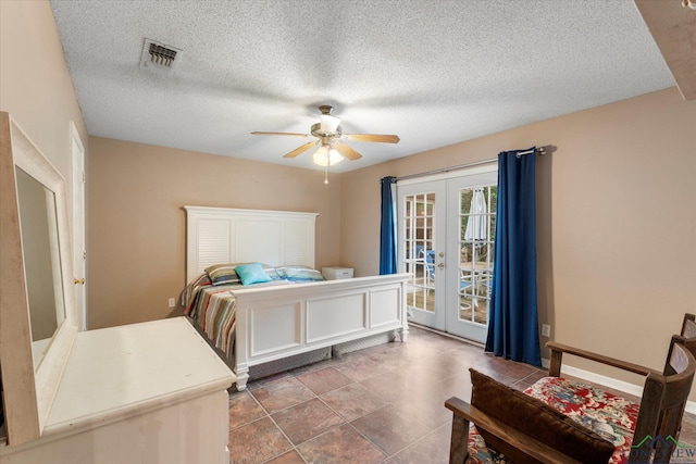 bedroom with access to exterior, ceiling fan, french doors, tile patterned flooring, and a textured ceiling