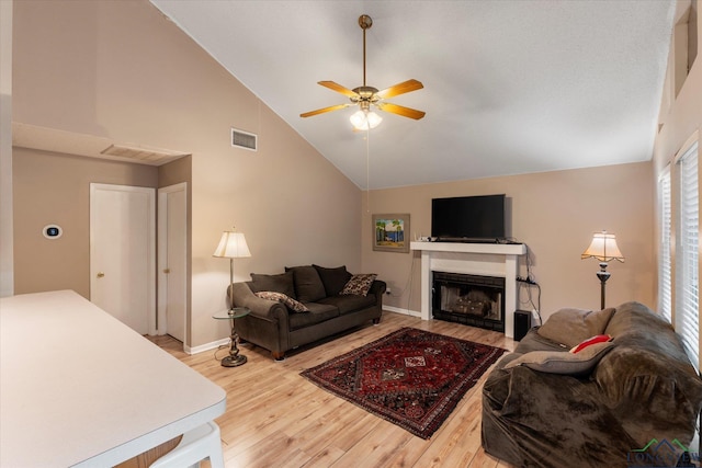 living room with ceiling fan, high vaulted ceiling, and wood-type flooring