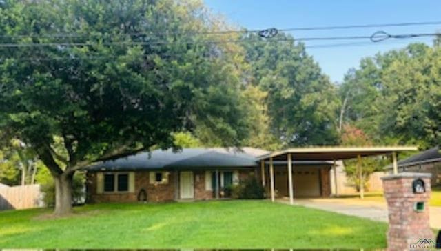 view of front of house with a front yard and a carport