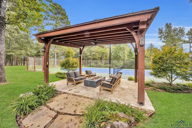 view of patio with a tennis court, fence, a fire pit, and ceiling fan