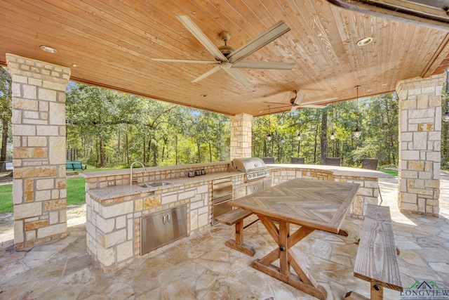 view of patio featuring ceiling fan, grilling area, an outdoor kitchen, and a sink