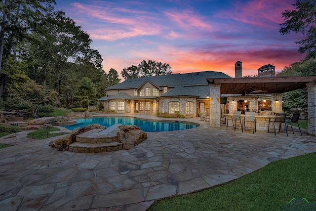 pool featuring a patio area and outdoor dry bar