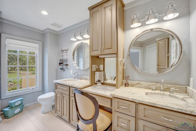 full bathroom with toilet, ornamental molding, two vanities, and a sink