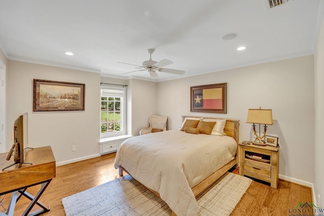 bedroom with baseboards, ornamental molding, recessed lighting, and light wood-style floors