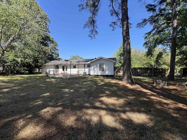 exterior space featuring a patio, a front lawn, and fence