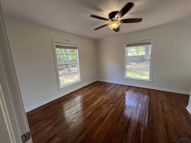 empty room with ceiling fan, ornamental molding, dark wood-style floors, and plenty of natural light